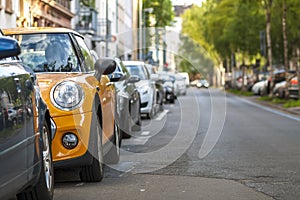 Rows of cars parked on the roadside in residential district