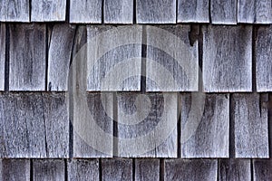 Rows of cedar shingles shrunk and faded gray with age