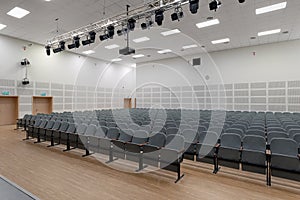 Rows of chairs in an empty auditorium hall