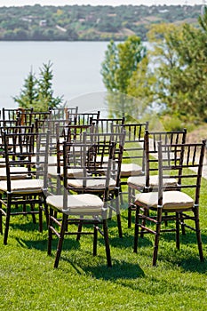 Rows of chairs for guests at an open-air wedding ceremony