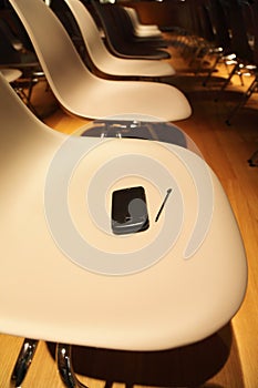 Rows of chairs; smartphone on chair