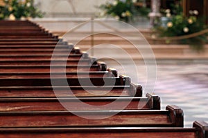 Rows of church benches. Polished wooden pews. Selective focus
