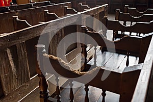 Rows of Church benches with sunlight close-up