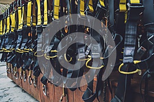 Rows of climbing safety ropes and carabiners and helmets