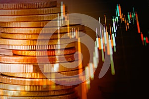 Rows of coin and graph of stock market trade indicator financial