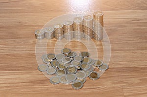 Rows of coin stacks on wooden floor. banking concept.