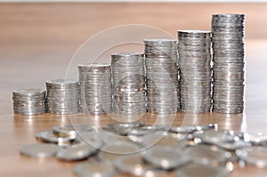 Rows of coin stacks on wooden floor. banking concept.