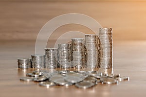 Rows of coin stacks on wooden floor. banking concept.