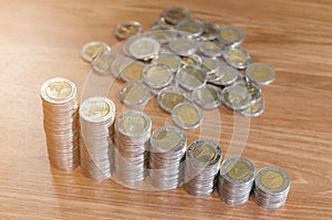 Rows of coin stacks on wooden floor. banking concept.