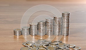 Rows of coin stacks on wooden floor. banking concept.