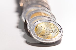 Rows of coins on white surface.