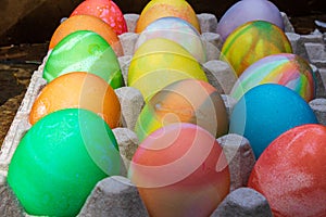 Rows of colored easter eggs in an egg carton
