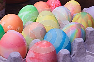 Rows of colored easter eggs in an egg carton