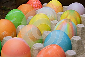 Rows of colored easter eggs in an egg carton