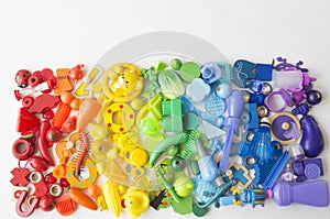 Rows of colorful rainbow toy bears.Very many kids toys rainbow color.Kids toys frame on white background. Top view. Flat lay.