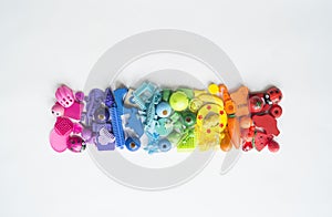 Rows of colorful rainbow toy bears.Very many kids toys rainbow color.Kids toys frame on white background. Top view. Flat lay.