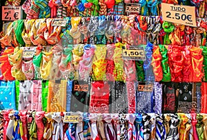 Rows of colorful scarves hanging at portuguese market photo