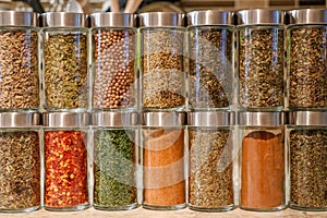 Rows of colorful spice jars neatly organized in a pantry