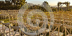 Rows and columns of chairs facing a Chuppah