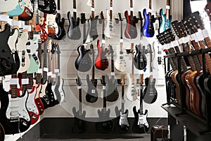 Rows of different guitars in store