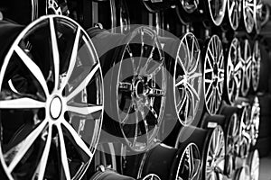 Rows of disks of various configurations in a shop window. Sale of disks and alloy wheels