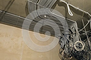Rows of electrical cables laid in the corrugates on the ceiling