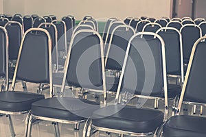 Rows of Empty Black Leather Chairs in a Meeting Room.