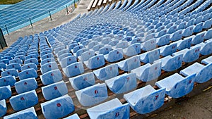 Rows of empty blue seats with numbers on the stadium