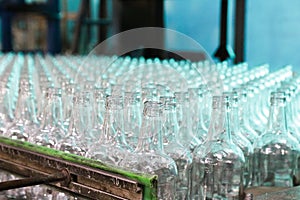rows of empty bottles at bottling plant with swallow depth of field