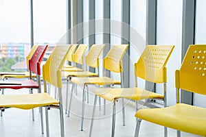 Rows of empty chairs await business seminar. Modern conference room interior. Corporate meeting space. Contemporary office