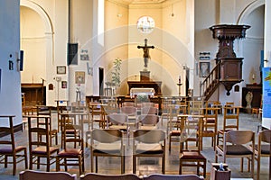Rows of empty chairs in a church