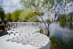 Rows of empty champagne or sparkling wine glasses.