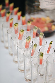 Rows of empty glasses and watermelon prepared for reception