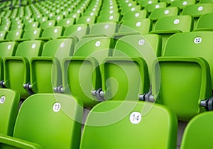 Rows of empty green stadium seats in outdoor arena
