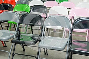 Rows of empty multicolor seats, chairs in auditorium, hall, classroom. Conference hall or seminar room. Selective focus.