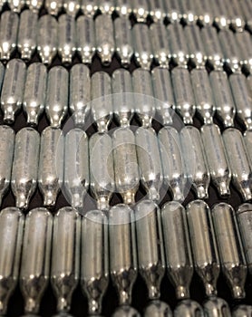 Rows of empty nitrous oxide cannisters / cream puff chargers: used as a legal high