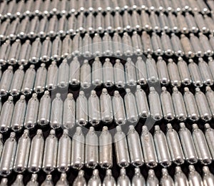 Rows of empty nitrous oxide cannisters / cream puff chargers: used as a legal high