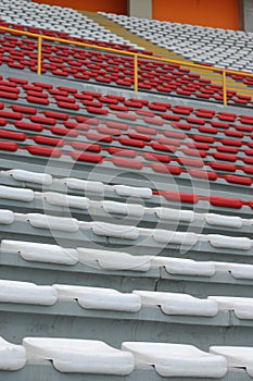 Rows of empty orange and white seats in the sports complex of the Estadio Nacional - Soccer Stadium - in Lima Peru photo