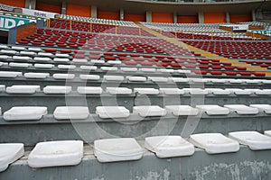 Rows of empty orange and white seats in the sports complex of the Estadio Nacional - Soccer Stadium - in Lima Peru photo