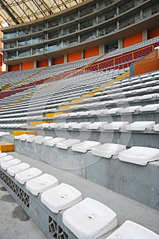 Rows of empty orange and white seats in the sports complex of the Estadio Nacional - Soccer Stadium - in Lima Peru photo