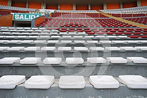 Rows of empty orange and white seats in the sports complex of the Estadio Nacional - Soccer Stadium - in Lima Peru