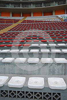 Rows of empty orange and white seats in the sports complex of the Estadio Nacional - Soccer Stadium - in Lima Peru photo