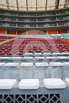 Rows of empty orange and white seats in the sports complex of the Estadio Nacional - Soccer Stadium - in Lima Peru photo