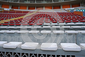 Rows of empty orange and white seats in the sports complex of the Estadio Nacional - Soccer Stadium - in Lima Peru photo