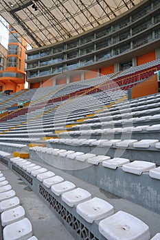 Rows of empty orange and white seats in the sports complex of the Estadio Nacional - Soccer Stadium - in Lima Peru photo