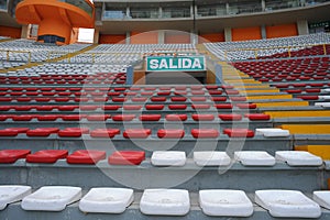 Rows of empty orange and white seats in the sports complex of the Estadio Nacional - Soccer Stadium - in Lima Peru