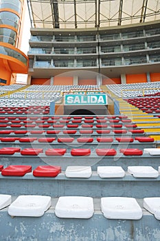 Rows of empty orange and white seats in the sports complex of the Estadio Nacional - Soccer Stadium - in Lima Peru photo