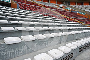 Rows of empty orange and white seats in the sports complex of the Estadio Nacional - Soccer Stadium - in Lima Peru