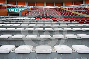 Rows of empty orange and white seats in the sports complex of the Estadio Nacional - Soccer Stadium - in Lima Peru photo