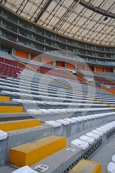 Rows of empty orange and white seats in the sports complex of the Estadio Nacional - Soccer Stadium - in Lima Peru photo